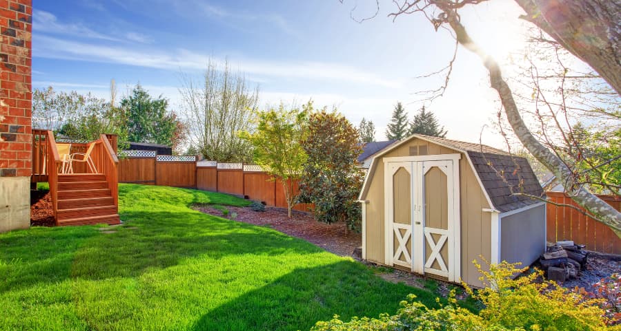 Fenced backyard with storage shed in Des Moines